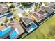 Aerial view of a yellow two-story home with a private backyard pool and fenced yard in a sunny neighborhood at 4982 Ne 124Th Rd, Oxford, FL 34484