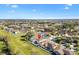 Aerial view shows the property's location within a sprawling residential area with lush greenery and clear skies at 4982 Ne 124Th Rd, Oxford, FL 34484