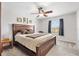 Comfortable bedroom features a large wooden bed frame and a ceiling fan at 4982 Ne 124Th Rd, Oxford, FL 34484