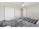 Comfortable bedroom featuring a ceiling fan, closet, neutral walls, and soft carpeting at 4982 Ne 124Th Rd, Oxford, FL 34484