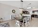 Dining area with a modern table, chairs, stylish light fixture, and views of the kitchen at 4982 Ne 124Th Rd, Oxford, FL 34484