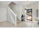 Inviting entryway with tile flooring, stairs to upper level and front door with exterior view at 4982 Ne 124Th Rd, Oxford, FL 34484