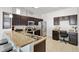 Well-lit kitchen with dark wood cabinets, stainless steel appliances, and granite countertops at 4982 Ne 124Th Rd, Oxford, FL 34484