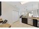 Spacious kitchen area with stainless steel dishwasher and view into the living room at 4982 Ne 124Th Rd, Oxford, FL 34484