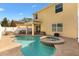 Backyard view of a stunning pool and spa, covered patio, and well-maintained landscaping at 4982 Ne 124Th Rd, Oxford, FL 34484