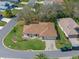 Overhead view of a home featuring a well-kept yard, mature trees, and surrounding neighborhood at 5533 Squires Dr, Leesburg, FL 34748