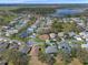 The aerial view of the neighborhood pinpoints the residence amidst a landscape of greenery and calm waters at 5533 Squires Dr, Leesburg, FL 34748