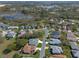 A wide aerial view displaying the property’s location in a residential area, near a water feature at 5533 Squires Dr, Leesburg, FL 34748