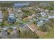 High-angle view showcases the home's placement in a tranquil and established residential community near a lake at 5533 Squires Dr, Leesburg, FL 34748