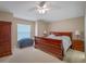 Inviting bedroom with a ceiling fan, a window, and a classic wooden bed frame at 5533 Squires Dr, Leesburg, FL 34748