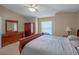 Serene bedroom showcasing a comfortable bed, natural light, and neutral tones at 5533 Squires Dr, Leesburg, FL 34748