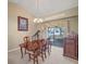 Elegant dining room featuring a chandelier and sliding glass doors to the outdoor area at 5533 Squires Dr, Leesburg, FL 34748