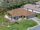 An eye-level view reveals a well-maintained, single-story home with a lush green lawn and manicured trees at 5533 Squires Dr, Leesburg, FL 34748