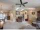 Open-concept living area with vaulted ceilings, neutral tones, and comfortable furniture at 5533 Squires Dr, Leesburg, FL 34748