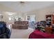 Comfortable living room with a ceiling fan and sliding glass doors leading to the patio at 5533 Squires Dr, Leesburg, FL 34748