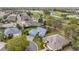 Aerial view of a neighborhood, golf course and waterfront property at 589 Society Hill Cir, The Villages, FL 32162