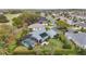 Aerial view of home with pool, patio and solar panels at 589 Society Hill Cir, The Villages, FL 32162