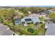 Aerial view of the home's backyard, featuring a screened-in pool, lush landscaping, and a clear view of the golf course at 589 Society Hill Cir, The Villages, FL 32162