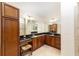 Bathroom with double sink vanity, granite countertops, and wood cabinets at 589 Society Hill Cir, The Villages, FL 32162