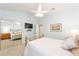 Bedroom featuring pale blue walls, carpeted floors, ceiling fan, and mirrored closet doors at 589 Society Hill Cir, The Villages, FL 32162