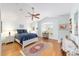 Bedroom with light blue walls, wooden floors, and a ceiling fan at 589 Society Hill Cir, The Villages, FL 32162