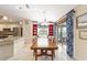 Bright dining area with a large window, ample natural light, and seamless access to the kitchen at 589 Society Hill Cir, The Villages, FL 32162