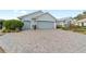 Paver driveway leading to a three-car garage at 589 Society Hill Cir, The Villages, FL 32162