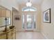 Bright foyer with tile flooring, a decorative front door, and elegant decor, creating a welcoming entrance at 589 Society Hill Cir, The Villages, FL 32162