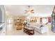 Open-concept living area with tile floors, ceiling fans, and a seamless flow into the kitchen and dining space at 589 Society Hill Cir, The Villages, FL 32162