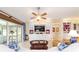 Bright living room with built-in entertainment center, and sliding glass doors leading to outdoor living at 589 Society Hill Cir, The Villages, FL 32162