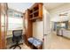 Mud room with storage shelves, desk, bench with patterned cushion, and tiled floor at 589 Society Hill Cir, The Villages, FL 32162