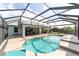 Backyard swimming pool with screened enclosure with beautiful landscaping and pool-side lounge at 589 Society Hill Cir, The Villages, FL 32162