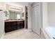 Bathroom features a double vanity with dark wood cabinets and a soaking tub at 5890 Sw 167Th Pl, Ocala, FL 34473