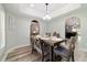 Cozy dining area with rustic table, bench seating, and views into other living spaces at 5890 Sw 167Th Pl, Ocala, FL 34473