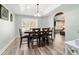 Elegant dining room with tray ceiling, stylish table set, and abundant natural light at 5890 Sw 167Th Pl, Ocala, FL 34473