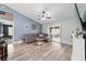 An open living space with hardwood floors and a gray sectional couch in a beautifully lit room at 5890 Sw 167Th Pl, Ocala, FL 34473