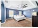 Comfortable main bedroom with tray ceilings, natural light, and neutral decor at 5890 Sw 167Th Pl, Ocala, FL 34473