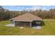 Back exterior of the house with screened-in porch and grill on the back patio at 5890 Sw 167Th Pl, Ocala, FL 34473