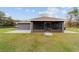 Rear exterior view of the home featuring a screened porch and spacious back yard at 5890 Sw 167Th Pl, Ocala, FL 34473