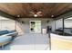 View of the screened lanai with a stained wood ceiling plus outdoor kitchen and grilling areas at 5890 Sw 167Th Pl, Ocala, FL 34473