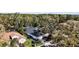 Aerial shot showcasing the home, two-car garage, landscaping, and screened-in pool at 6035 Falconbridge Pl, Mount Dora, FL 32757