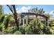 Exterior view of the screened-in pool area surrounded by lush landscaping for privacy at 6035 Falconbridge Pl, Mount Dora, FL 32757