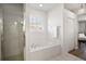 Bright primary bathroom features a walk-in shower and a soaking tub at 6035 Falconbridge Pl, Mount Dora, FL 32757