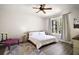 Bright bedroom with neutral tones, ceiling fan, and a large window offering natural light at 6035 Falconbridge Pl, Mount Dora, FL 32757