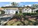 Charming single-story home featuring a two-car garage, well-maintained lawn, and inviting front entrance at 6035 Falconbridge Pl, Mount Dora, FL 32757