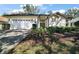 Charming single-story home featuring a two-car garage, manicured landscaping, and a welcoming entrance at 6035 Falconbridge Pl, Mount Dora, FL 32757