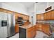 Beautiful kitchen boasts granite countertops, stainless steel appliances, and custom wood cabinetry at 6035 Falconbridge Pl, Mount Dora, FL 32757