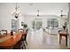 Bright and open-concept living area featuring tiled floors and sliding glass doors to the pool at 6035 Falconbridge Pl, Mount Dora, FL 32757