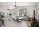 Open-concept living space with vaulted ceiling, tile floors, large sectional sofa, and natural light at 6035 Falconbridge Pl, Mount Dora, FL 32757