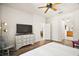 Spacious primary bedroom features a ceiling fan and en-suite bathroom at 6035 Falconbridge Pl, Mount Dora, FL 32757